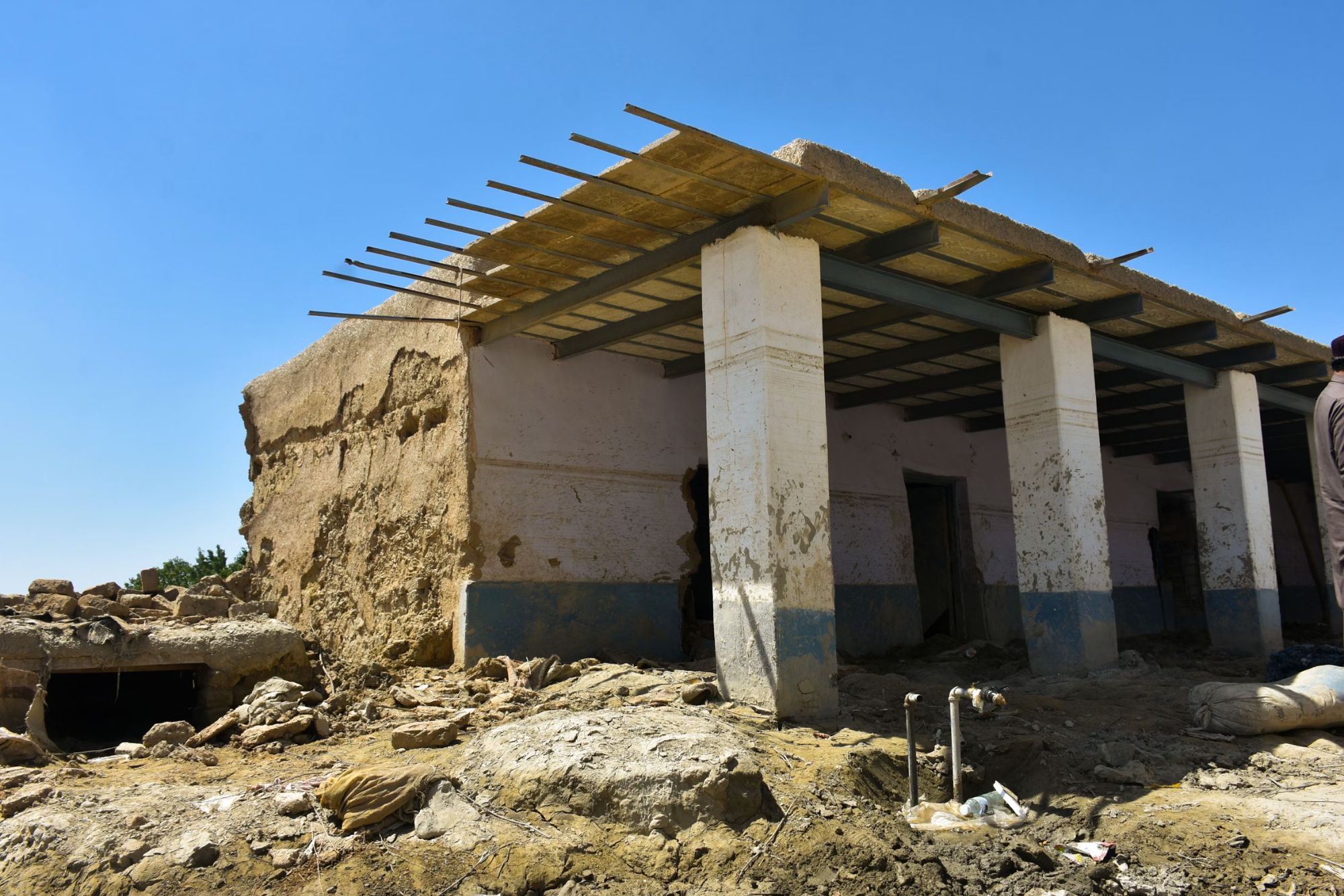 A man stands before a building site in Austin, TX, representing construction and renovation services in the area.
