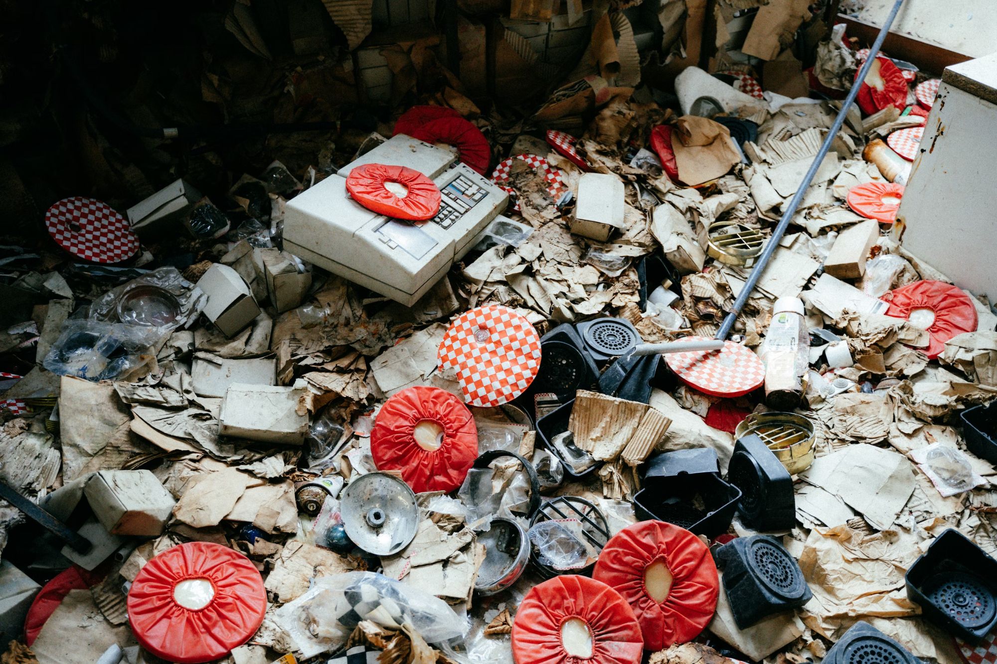 A disorganized indoor space filled with a pile of papers and various items, representing junk removal services in Austin, TX.